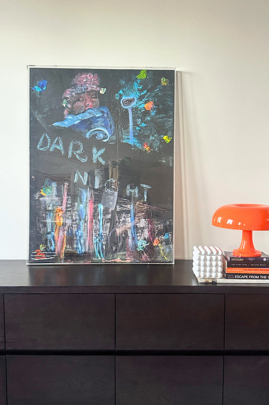 Framed artwork with 'Dark Night' text on a dark surface